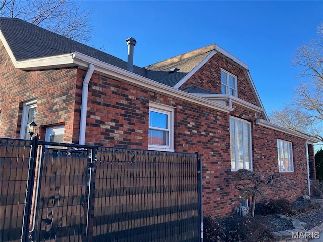 550 N 4th St, Breese, IL 62230 - view of side of home featuring brick siding, a shingled roof, and fence