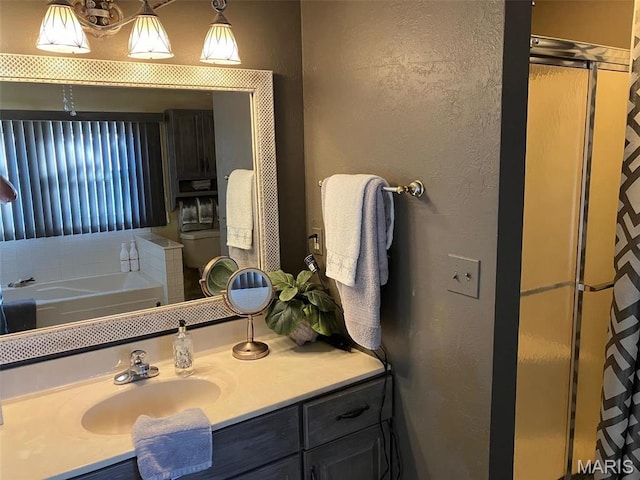 550 N 4th St, Breese, IL 62230 - bathroom featuring a stall shower, a textured wall, vanity, and a garden tub