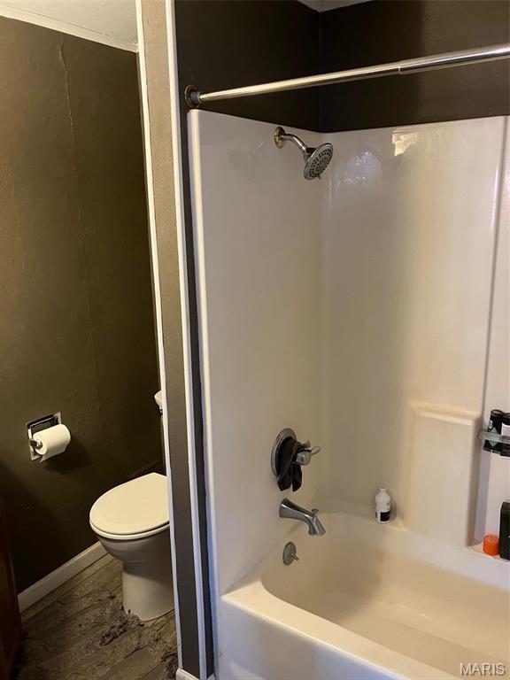 550 N 4th St, Breese, IL 62230 - bathroom with toilet, wood finished floors, and bathing tub / shower combination