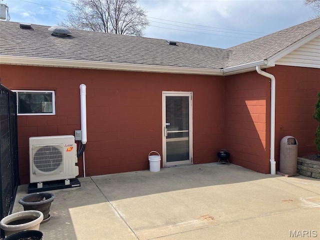 550 N 4th St, Breese, IL 62230 - back of house with a shingled roof, concrete block siding, a cooling unit, and a patio