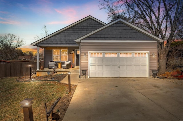 703 Locust St, Desloge, MO 63601 - view of front of home with concrete driveway, a garage, covered porch, outdoor lounge area, and fence
