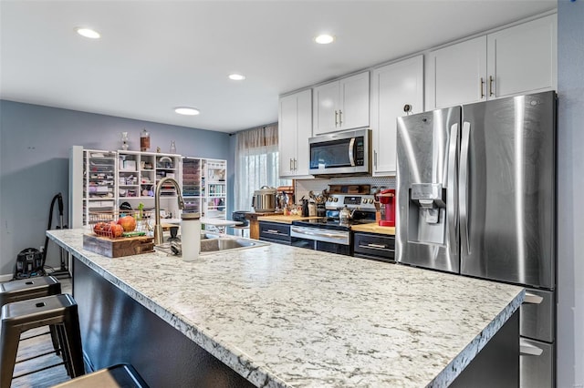 703 Locust St, Desloge, MO 63601 - kitchen with appliances with stainless steel finishes, a sink, light countertops, white cabinetry, and recessed lighting