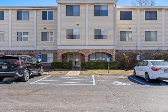 view of building exterior with uncovered parking