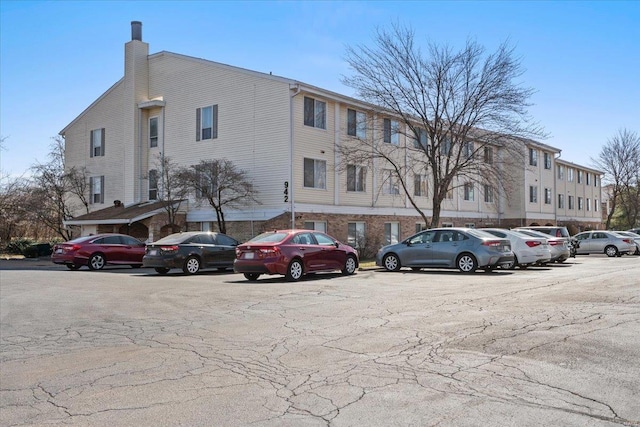 view of building exterior featuring uncovered parking