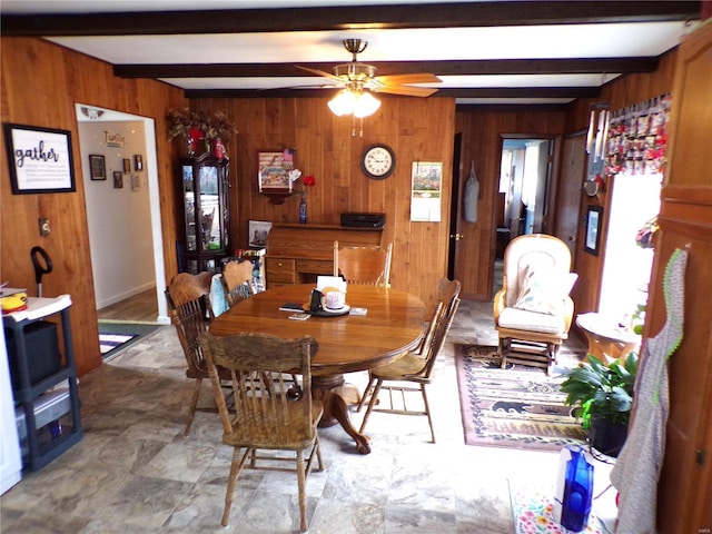 508 N Galloway Rd, Vandalia, MO 63382 - dining space with wood walls, beam ceiling, healthy amount of natural light, and a ceiling fan