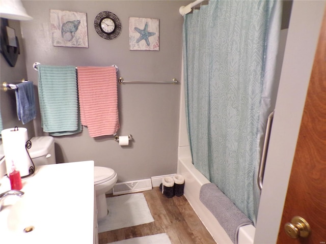 508 N Galloway Rd, Vandalia, MO 63382 - bathroom with toilet, wood finished floors, shower / bath combo with shower curtain, and baseboards