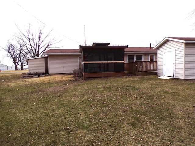 508 N Galloway Rd, Vandalia, MO 63382 - back of property with a sunroom, a yard, an outdoor structure, and a storage shed