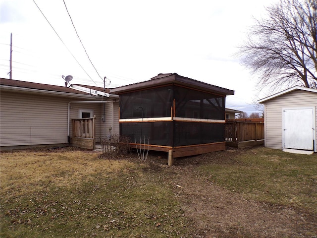 508 N Galloway Rd, Vandalia, MO 63382 - rear view of house with a sunroom, a storage shed, a yard, and an outdoor structure
