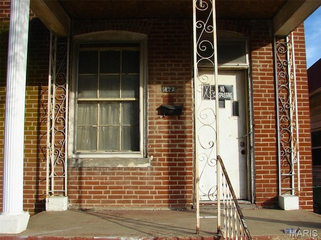 property entrance with brick siding