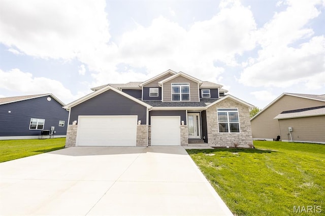 135 Reagan Dr, Troy, IL 62294 - craftsman house featuring stone siding, a front lawn, driveway, and an attached garage