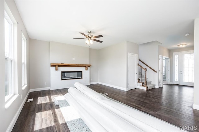 135 Reagan Dr, Troy, IL 62294 - living room with dark wood-style floors, stairway, baseboards, a glass covered fireplace, and ceiling fan