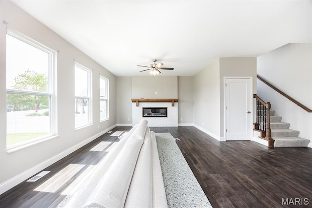 135 Reagan Dr, Troy, IL 62294 - unfurnished living room featuring dark wood-type flooring, a ceiling fan, baseboards, stairs, and a glass covered fireplace