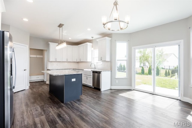 135 Reagan Dr, Troy, IL 62294 - kitchen with stainless steel appliances, a kitchen island, a chandelier, backsplash, and dark wood-style floors