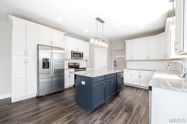 135 Reagan Dr, Troy, IL 62294 - kitchen featuring stainless steel appliances, blue cabinetry, a sink, white cabinets, and dark wood-style floors