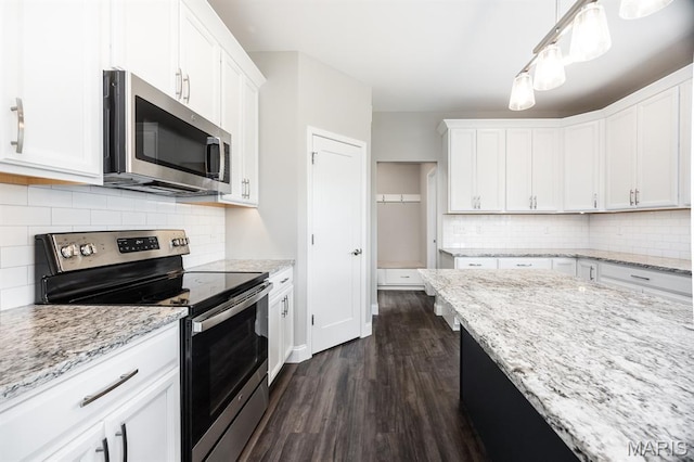 135 Reagan Dr, Troy, IL 62294 - kitchen featuring appliances with stainless steel finishes, dark wood-style floors, white cabinetry, and decorative backsplash