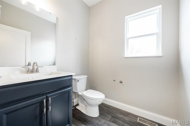 135 Reagan Dr, Troy, IL 62294 - bathroom featuring vanity, toilet, baseboards, and wood finished floors