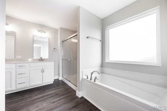 135 Reagan Dr, Troy, IL 62294 - full bath featuring vanity, a garden tub, a shower stall, and wood finished floors