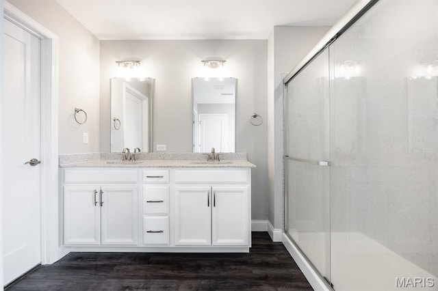 135 Reagan Dr, Troy, IL 62294 - bathroom with double vanity, wood finished floors, and a shower stall