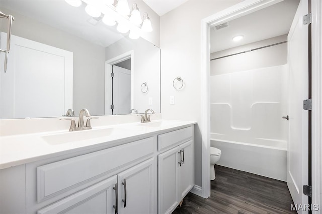 135 Reagan Dr, Troy, IL 62294 - full bath featuring toilet, double vanity, wood finished floors, and bathtub / shower combination