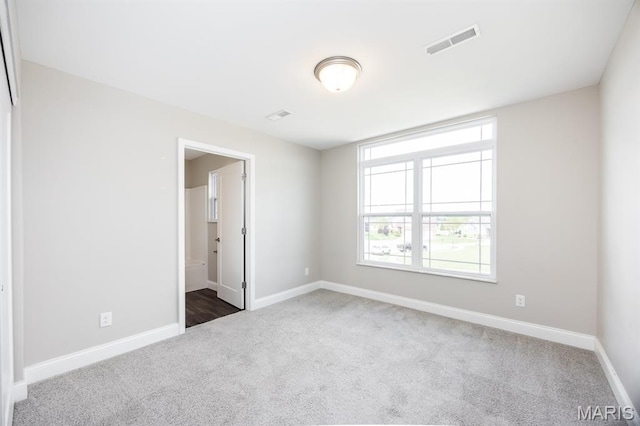 135 Reagan Dr, Troy, IL 62294 - spare room featuring dark colored carpet, healthy amount of natural light, and baseboards