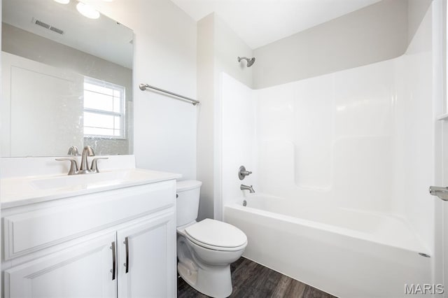 135 Reagan Dr, Troy, IL 62294 - full bathroom with wood finished floors, vanity, toilet, and washtub / shower combination