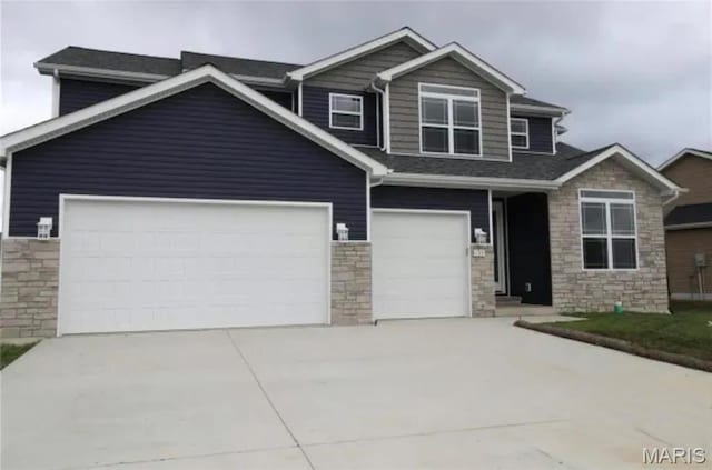 135 Reagan Dr, Troy, IL 62294 - craftsman inspired home with stone siding, driveway, and an attached garage