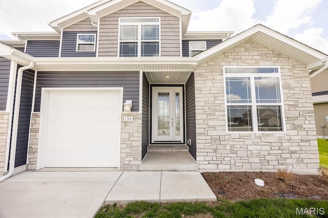 135 Reagan Dr, Troy, IL 62294 - view of front of property featuring stone siding, an attached garage, and concrete driveway