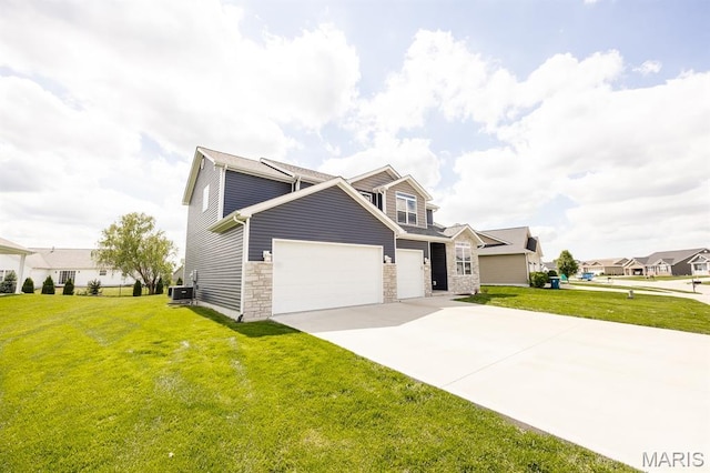135 Reagan Dr, Troy, IL 62294 - view of front of house featuring an attached garage, central AC unit, driveway, a front lawn, and stone siding