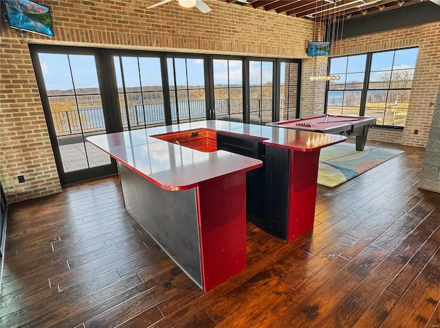 6 E Front St Unit 6, Washington, MO 63090 - kitchen featuring brick wall, dark wood finished floors, a towering ceiling, a center island, and pool table