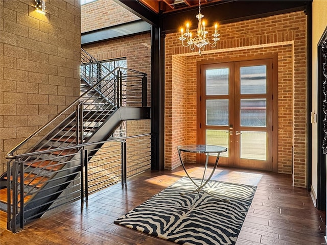 6 E Front St Unit 6, Washington, MO 63090 - doorway featuring wood-type flooring, french doors, a chandelier, healthy amount of natural light, and brick wall
