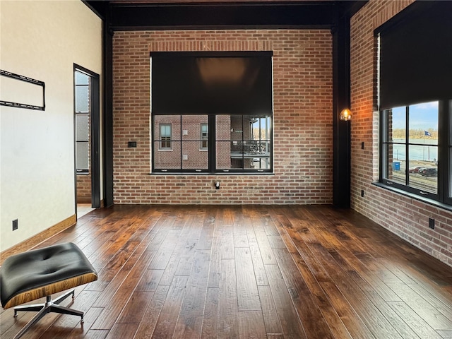 6 E Front St Unit 6, Washington, MO 63090 - spare room with hardwood / wood-style floors, brick wall, and baseboards
