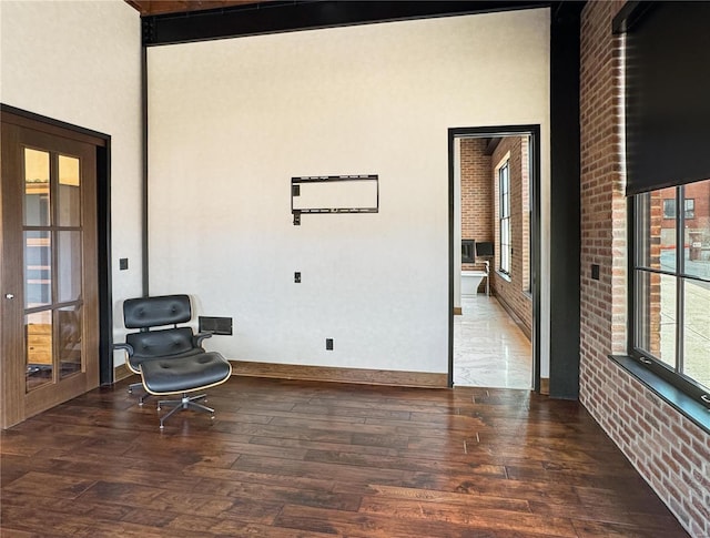 6 E Front St Unit 6, Washington, MO 63090 - unfurnished room featuring wood finished floors, a towering ceiling, and brick wall