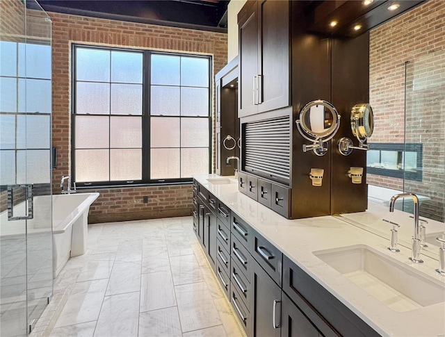 6 E Front St Unit 6, Washington, MO 63090 - full bath featuring brick wall, double vanity, a soaking tub, a shower stall, and marble finish flooring
