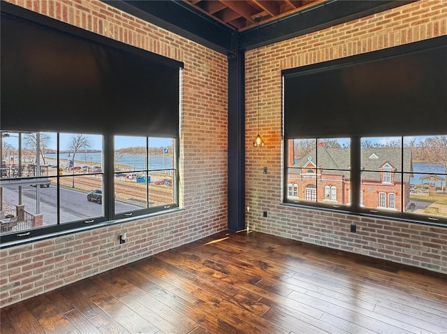 6 E Front St Unit 6, Washington, MO 63090 - unfurnished room with hardwood / wood-style floors, brick wall, and plenty of natural light