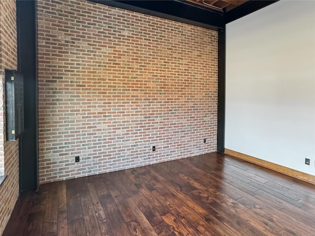 6 E Front St Unit 6, Washington, MO 63090 - empty room with brick wall, dark wood-style floors, and baseboards