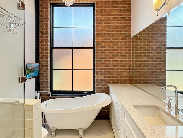 6 E Front St Unit 6, Washington, MO 63090 - bathroom with brick wall, a freestanding tub, vanity, and tile patterned floors