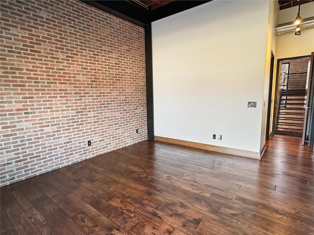 6 E Front St Unit 6, Washington, MO 63090 - spare room with dark wood-style flooring and brick wall