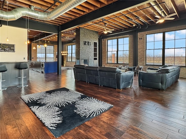 6 E Front St Unit 6, Washington, MO 63090 - living area featuring wood-type flooring, healthy amount of natural light, beam ceiling, brick wall, and a ceiling fan