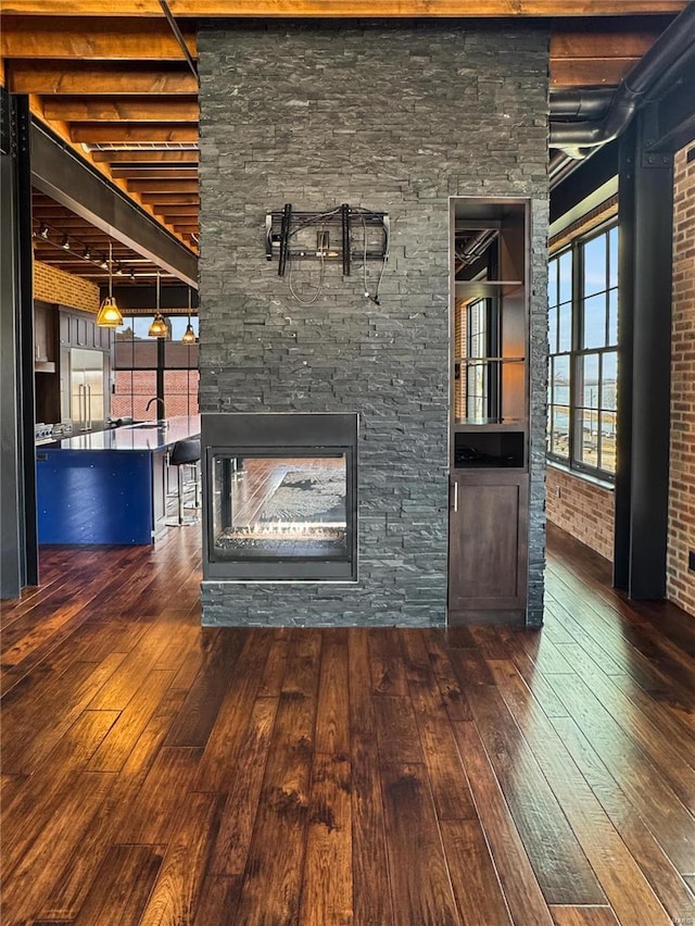 6 E Front St Unit 6, Washington, MO 63090 - unfurnished living room featuring hardwood / wood-style flooring, a fireplace, and beamed ceiling