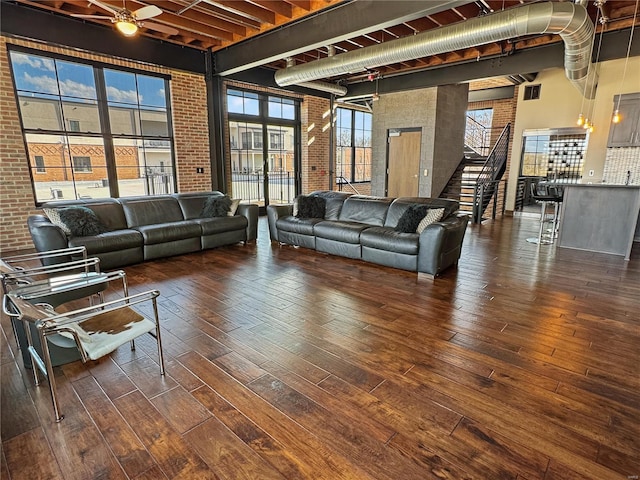 6 E Front St Unit 6, Washington, MO 63090 - living area with brick wall, wood-type flooring, healthy amount of natural light, a towering ceiling, and stairway
