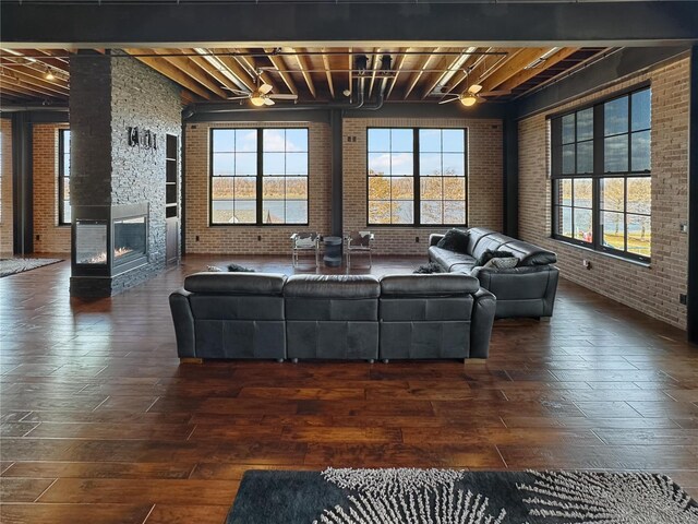 6 E Front St Unit 6, Washington, MO 63090 - living area featuring brick wall, healthy amount of natural light, beamed ceiling, wood-type flooring, and a fireplace