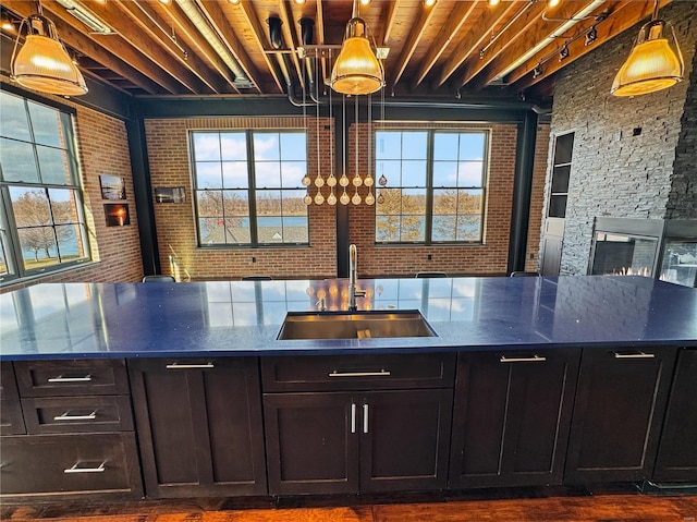 6 E Front St Unit 6, Washington, MO 63090 - bar featuring a sink, plenty of natural light, pendant lighting, dark wood finished floors, and brick wall