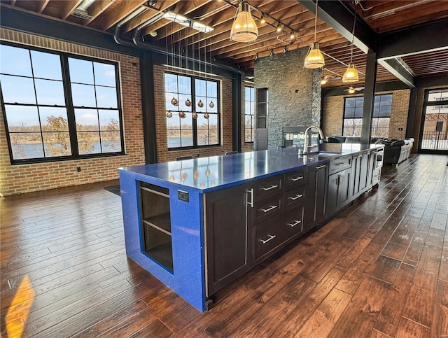 6 E Front St Unit 6, Washington, MO 63090 - kitchen with dark wood-type flooring, open floor plan, dark countertops, a sink, and beamed ceiling