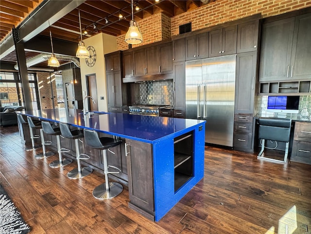 6 E Front St Unit 6, Washington, MO 63090 - kitchen featuring built in fridge, dark countertops, dark wood-style flooring, beam ceiling, and tasteful backsplash