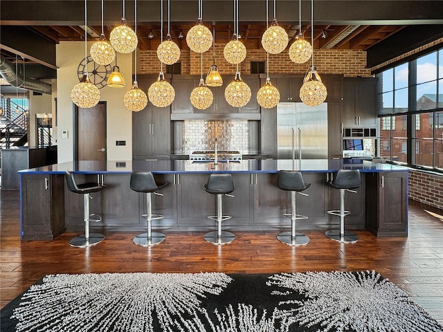 6 E Front St Unit 6, Washington, MO 63090 - bar area with stainless steel built in refrigerator, dark wood-style flooring, beamed ceiling, decorative light fixtures, and backsplash