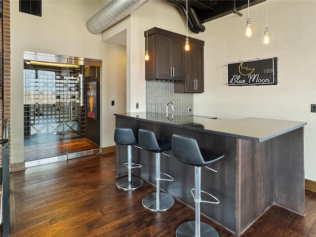 6 E Front St Unit 6, Washington, MO 63090 - bar area with dark wood finished floors, decorative backsplash, baseboards, and a sink