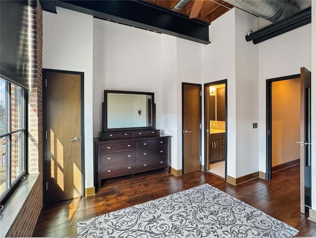 6 E Front St Unit 6, Washington, MO 63090 - bedroom with dark wood-type flooring, a high ceiling, baseboards, and ensuite bath