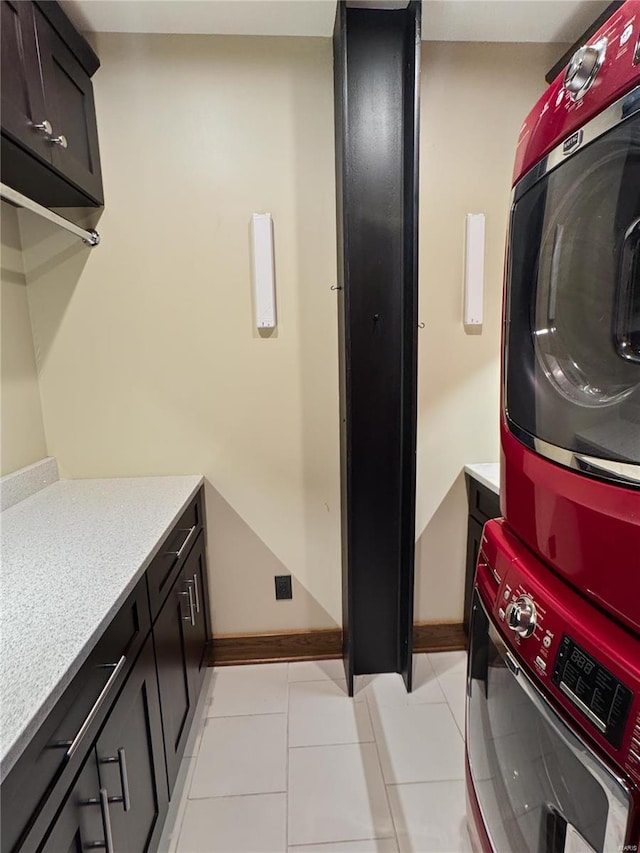 6 E Front St Unit 6, Washington, MO 63090 - washroom with stacked washer and clothes dryer, cabinet space, light tile patterned floors, and baseboards