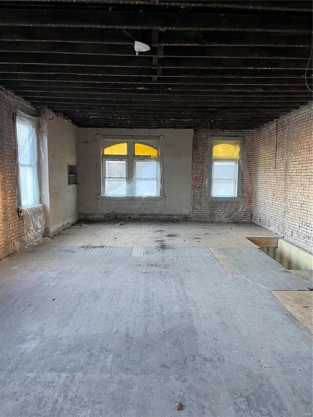 miscellaneous room with plenty of natural light and brick wall
