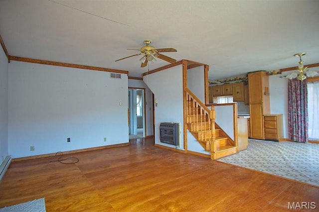 1153 Red Fox Rd, Camdenton, MO 65324 - unfurnished living room with stairs, ceiling fan, ornamental molding, baseboards, and heating unit